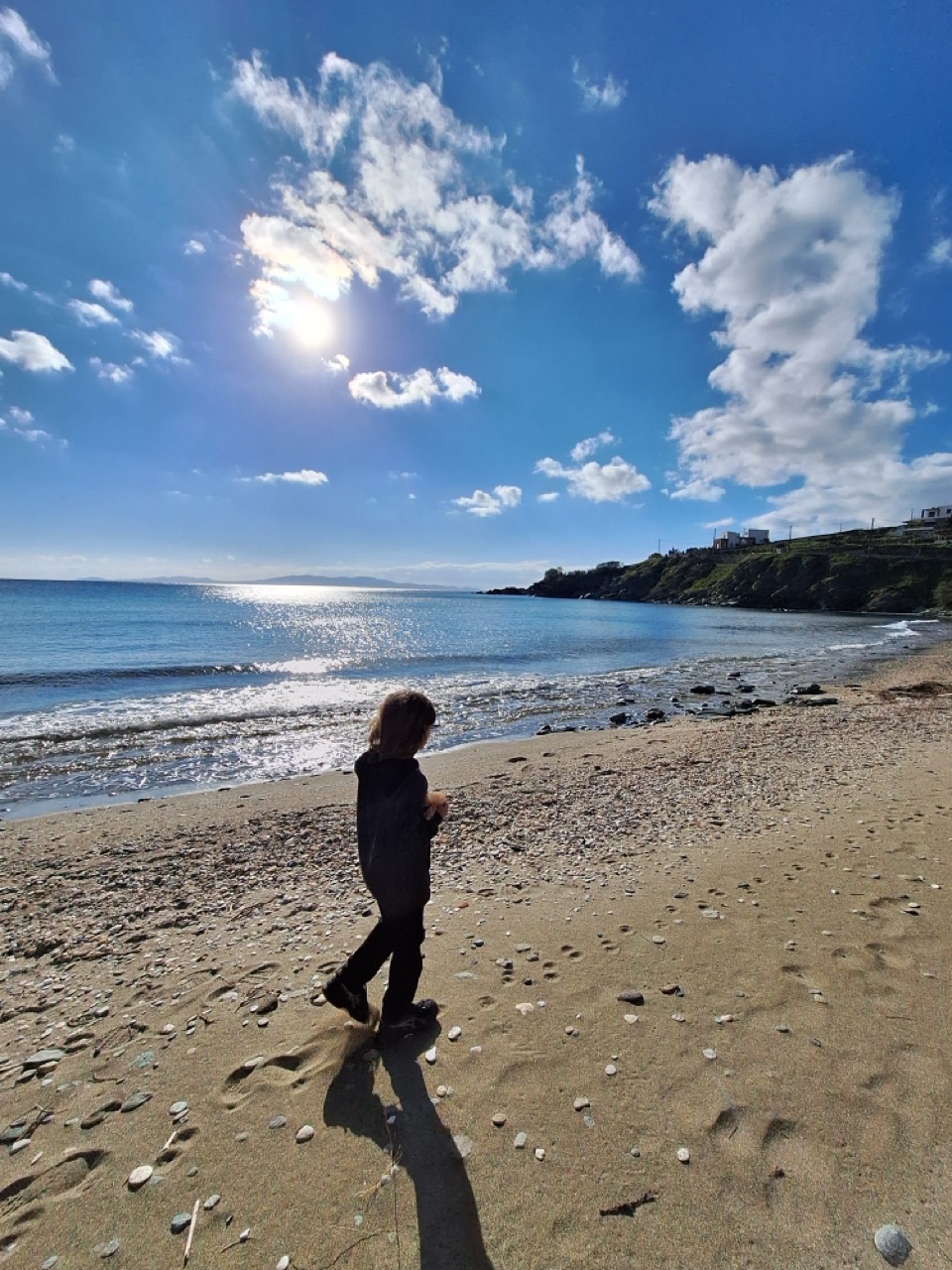 Tinos pebbly beach at golden hour